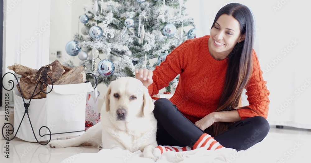 Young woman and her dog celebrating Christmas Young woman and her dog celebrating Christmas