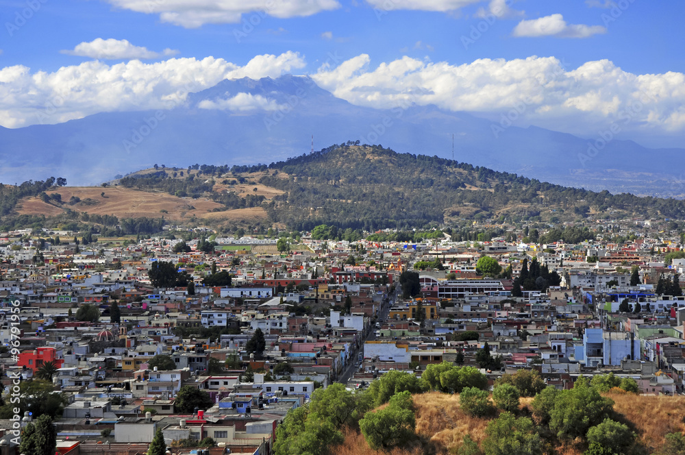 Characterized by its vibrantly colored buildings and narrow streets, Puebla is a popular spot for tourists, despite being built under multiple active volcanoes. 