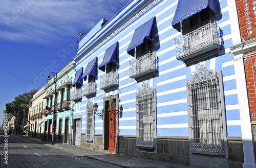 Characterized by its vibrantly colored buildings and narrow streets, Puebla is a popular spot for tourists, despite being built under multiple active volcanoes.  photo