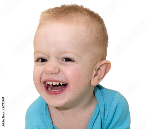 Portrait of the laughing kid close up. It is isolated on a white