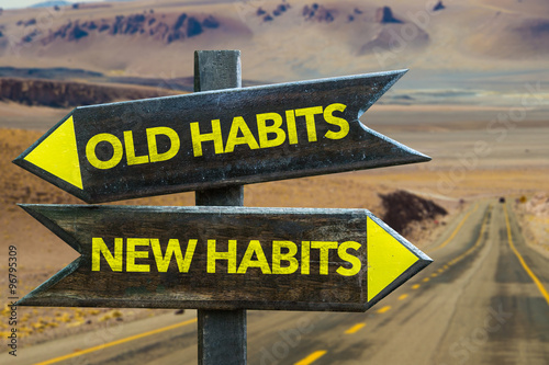 Old Habits - New Habits signpost in a desert road background photo