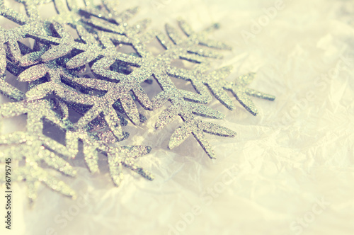 Snowflakes - Christmas ornament on textural white crumpled paper. A background for Christmas vacation. A decorative card with Christmas snowflakes.