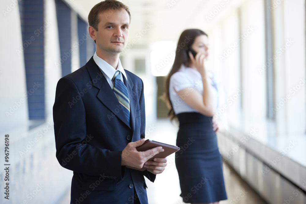business woman with a telephone and a businessman with a tablet business woman with a telephone and a businessman with a tablet