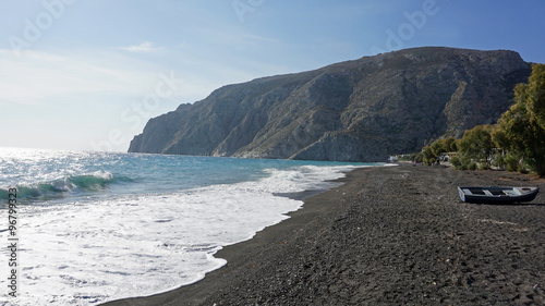 volcanic beach in kamari on santorini siland photo