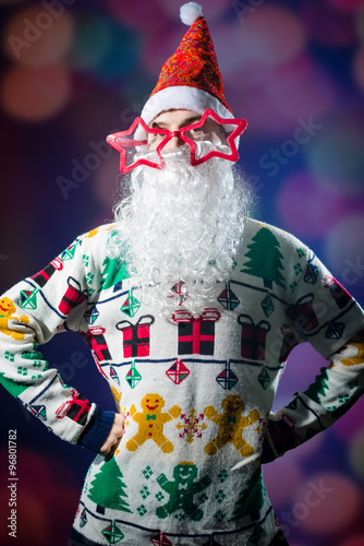 Funny hipster young man wearing Santa beard and funny glasses