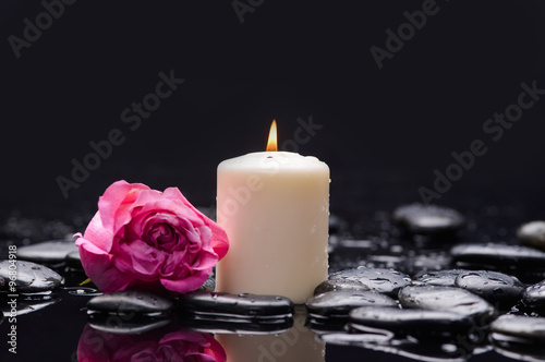 Still life with pink rose  petals with pink candle and therapy stones 
