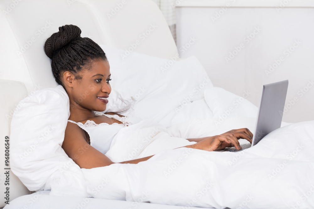 Woman Using Laptop On Bed Woman Using Laptop On Bed