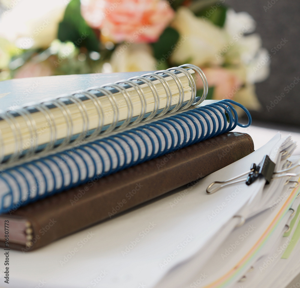 Notebooks and stack of document Notebooks and stack of document