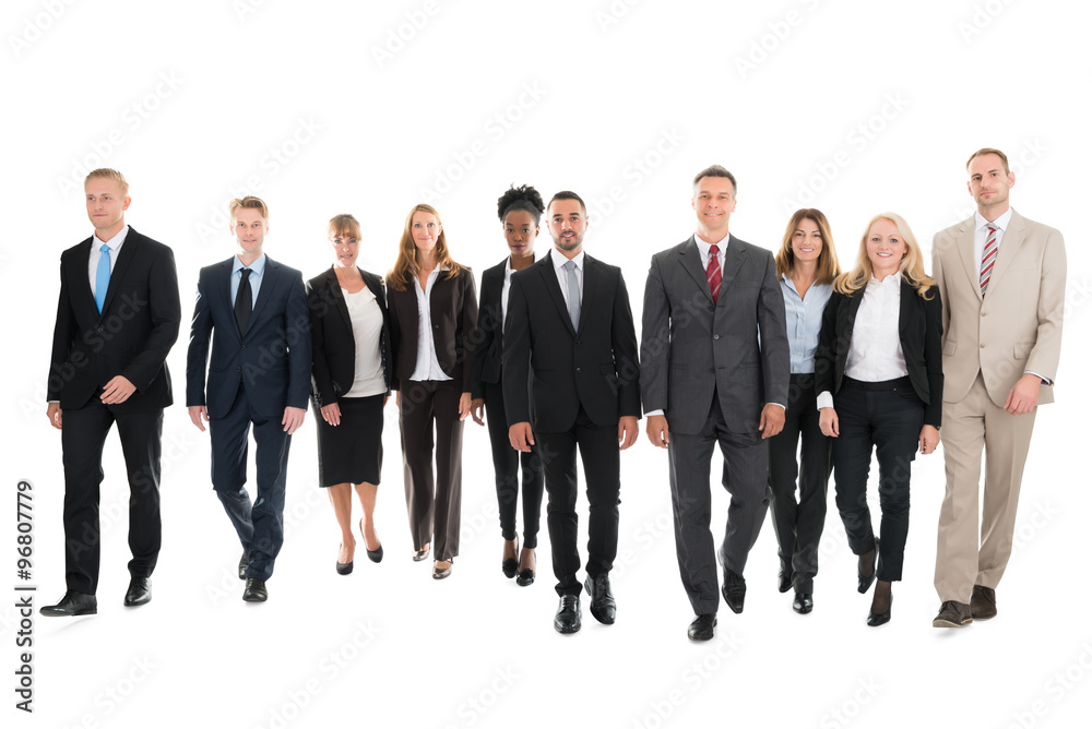 Confident Business Team Walking Against White Background Confident Business Team Walking Against White Background