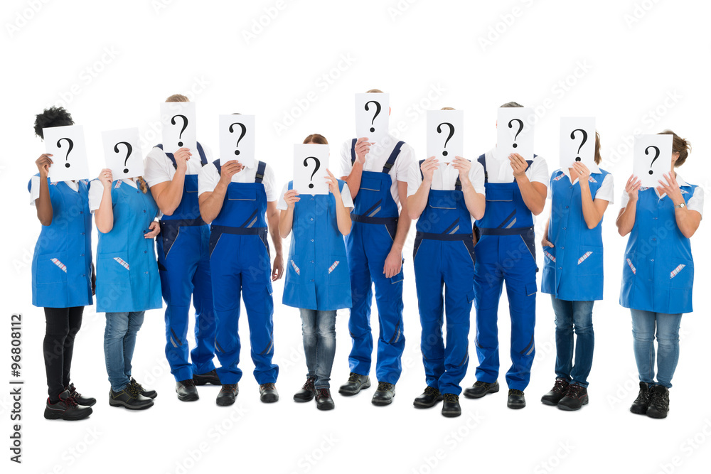 Fototapeta premium Janitors Hiding Faces With Question Mark Signs