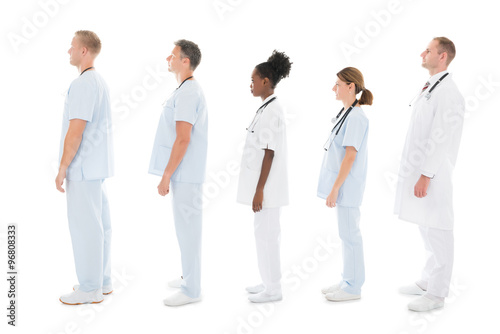 Side View Of Medical Team Standing In Row