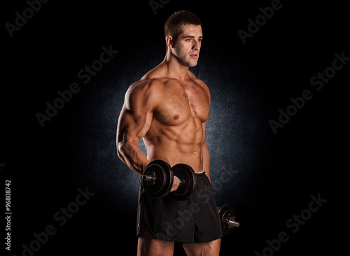 Muscular Bodybuilder Guy Doing Exercises With Dumbbells © romanolebedev
