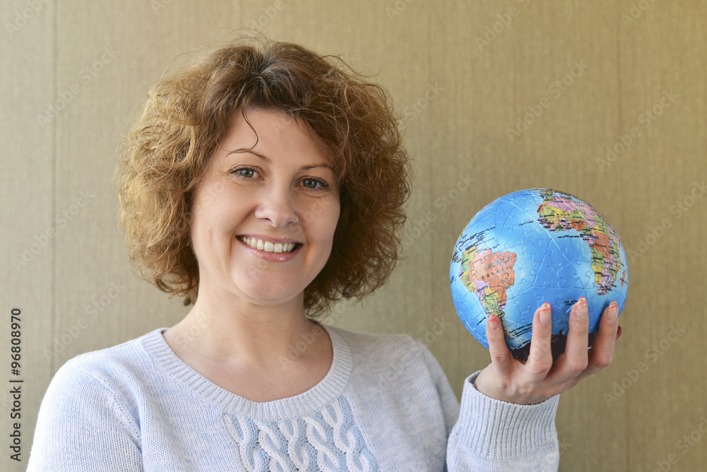 Woman with globe in hands thinking about traveling Woman with globe in hands thinking about traveling