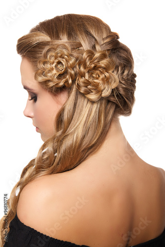 portrait of a beautiful young blonde woman on a light background with hairdo on her head. copy space.