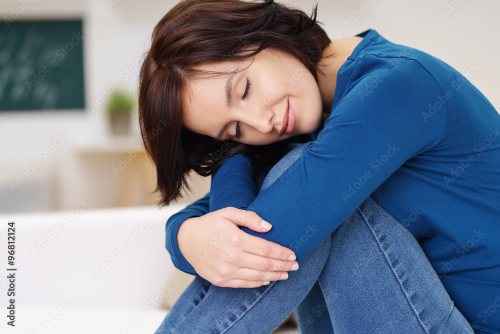 entspannte junge frau legt den kopf auf die knie entspannte junge frau legt den kopf auf die knie