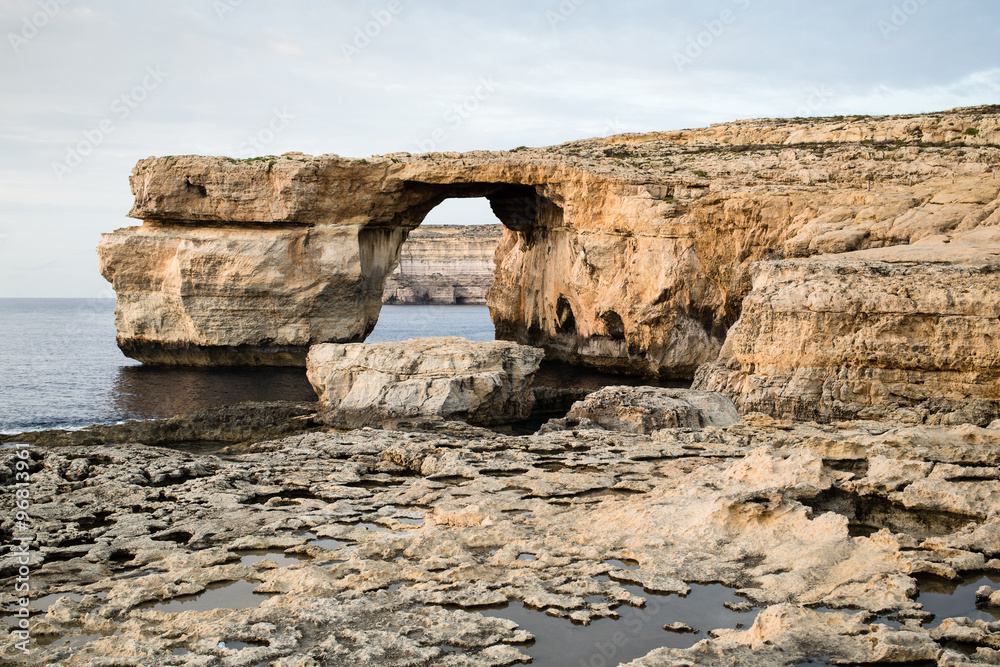 Azure Window, natural arch on Gozo island in cloudy weather Azure Window, natural arch on Gozo island in cloudy weather