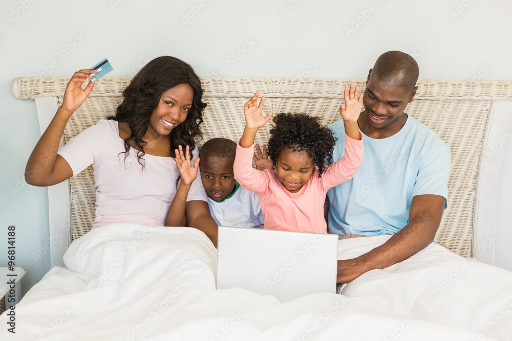 Happy family shopping online with laptop Happy family shopping online with laptop