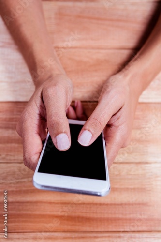 Cuadro en lienzo Part of hands typing on smartphone