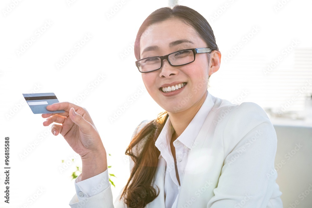 Smiling businesswoman using a credit card