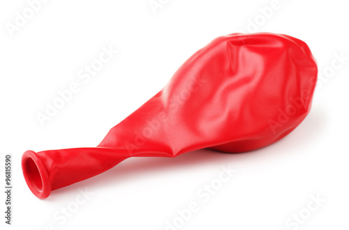 Deflated red rubber balloon