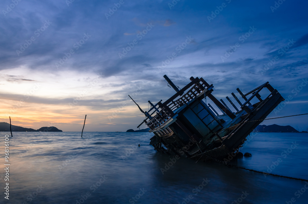 Wreck ship on the beach in sunrise