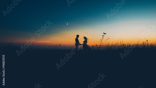 silhouette of couple with sunset background