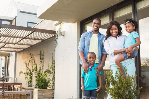 Happy african american family standing in the garden 