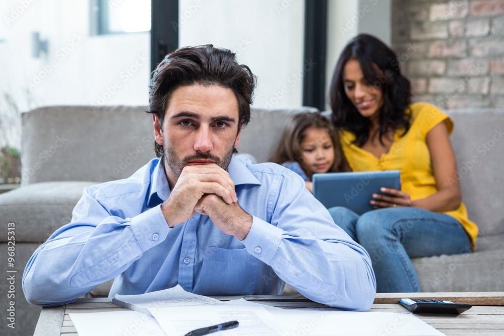 Worried father in living room looking at the camera Worried father in living room looking at the camera