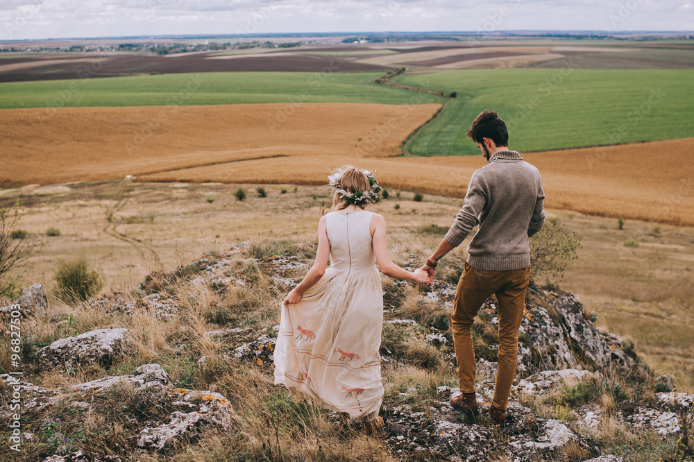 couple in the field near the mountains