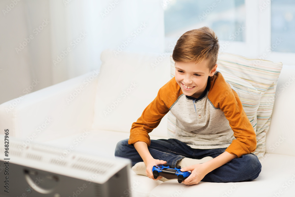 happy boy with joystick playing video game at home happy boy with joystick playing video game at home