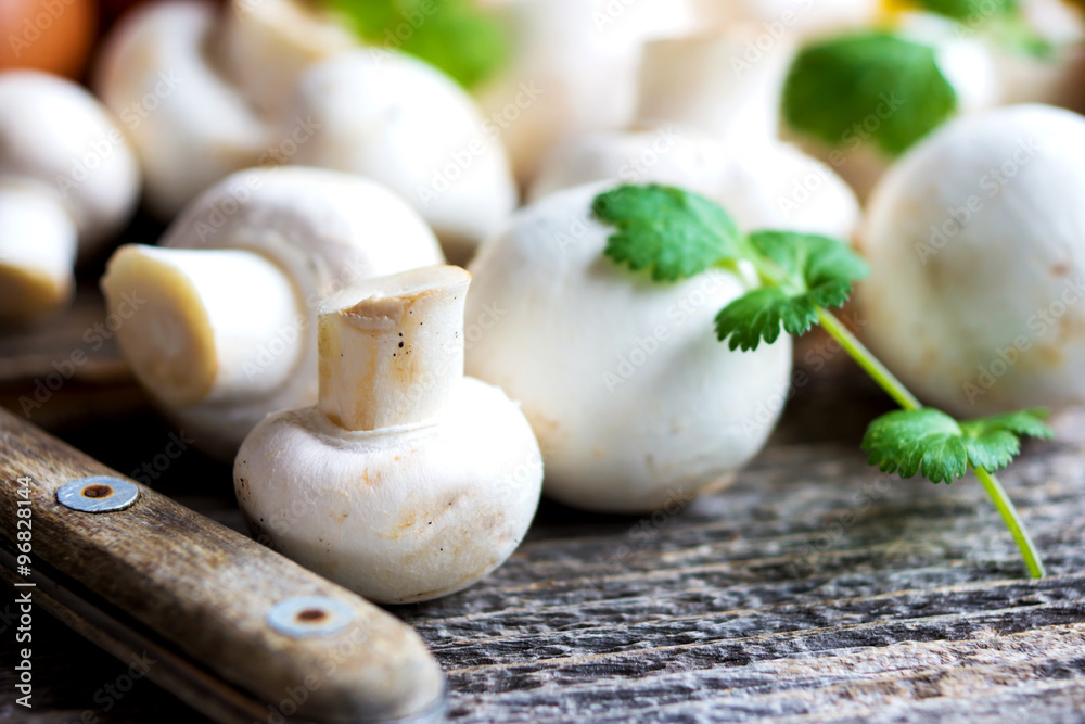 Fresh mushrooms champignons on wooden background Fresh mushrooms champignons on wooden background