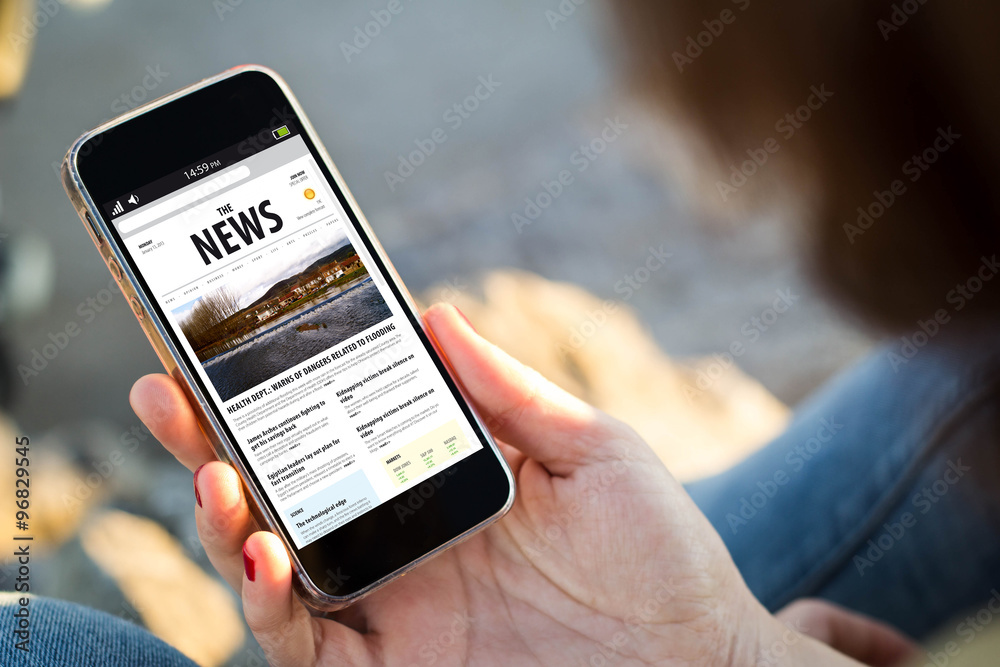 woman sitting in the street holding her smartphone with news - obrazy, fototapety, plakaty 