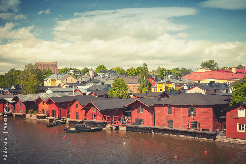 Old red wooden houses on river coast in Porvoo