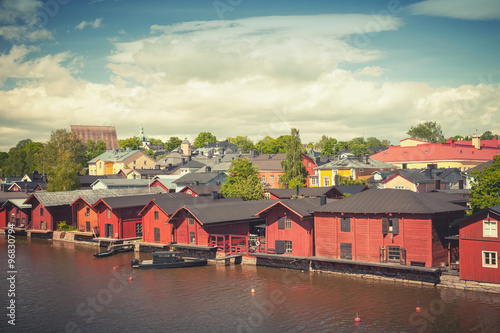 Old red wooden houses on river coast in Porvoo