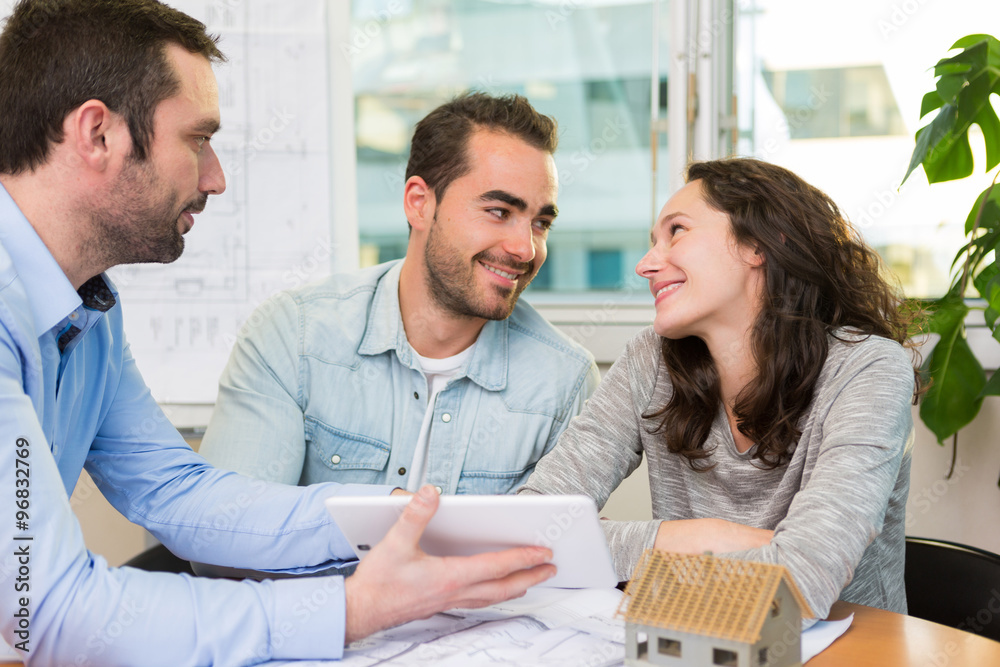 Fototapeta premium Young attractive people meeting real estate agent at the office