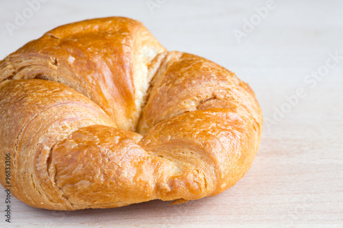 Fresh croissant on a wooden board
