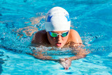 Teen boy swimming breaststroke.