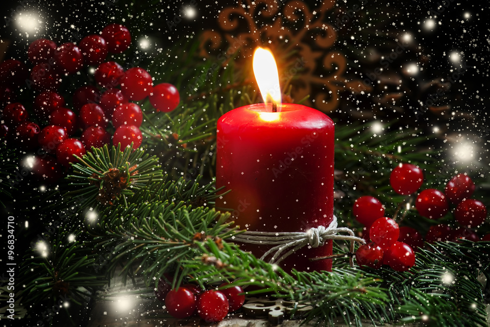 Fototapeta Christmas or New Year's dark composition with burning red candle