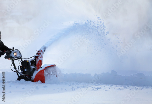 man working with snow blower photo