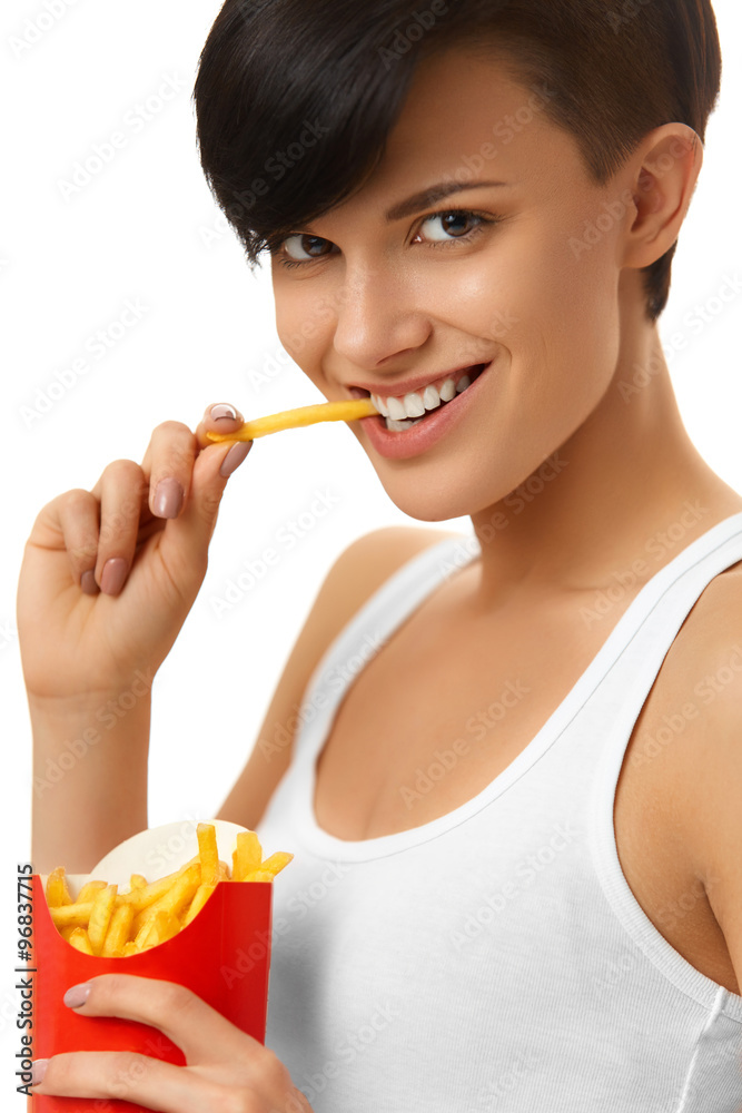 Eating Fast Food. Portrait Of Happy Caucasian Woman Eating French Fries Chips ( Fried Potatoes ) Against White Background. Unhealthy Junk Food. Nutrition. Lifestyle Eating Fast Food. Portrait Of Happy Caucasian Woman Eating French Fries Chips ( Fried Potatoes ) Against White Background. Unhealthy Junk Food. Nutrition. Lifestyle