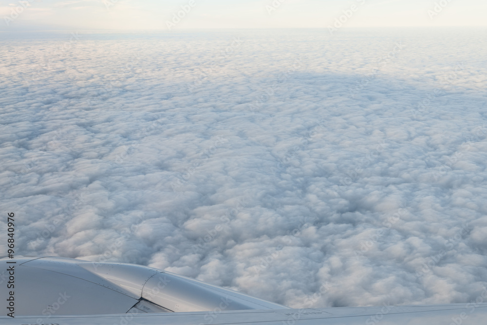 Clouds and sky as seen through window of an aircraft Clouds and sky as seen through window of an aircraft