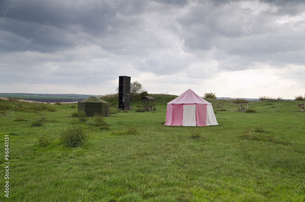 Dramatic clouds and an ancient camp, restored from medieval time