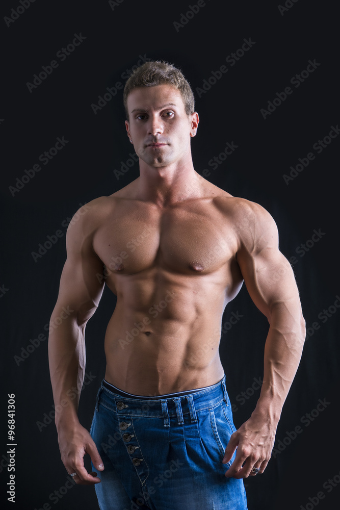 Fototapeta premium Attractive young man with naked muscular torso, wearing jeans