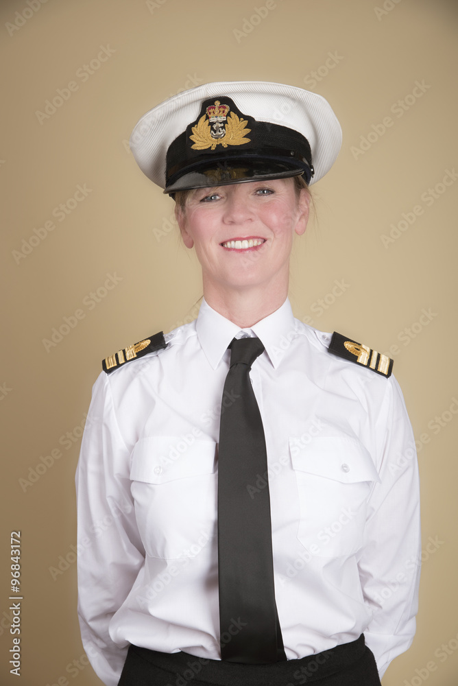 Female naval Lt Commander in uniform standing to attention Female naval Lt Commander in uniform standing to attention