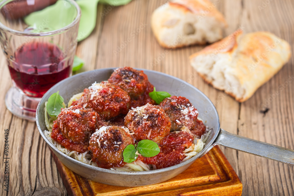 Homemade meatball with Italian pasta in frying pan Homemade meatball with Italian pasta in frying pan