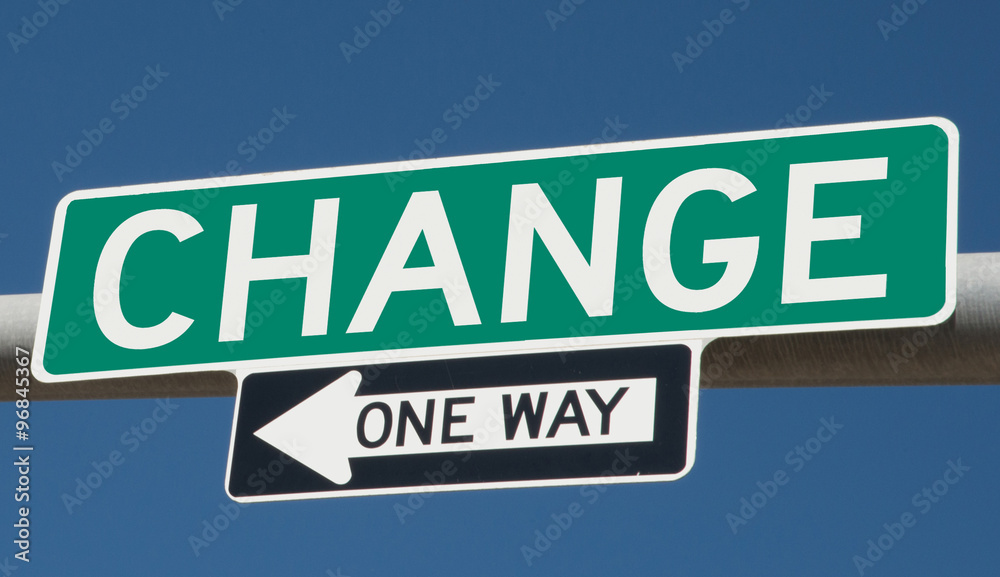 Change on green overhead highway sign with one way arrow 
