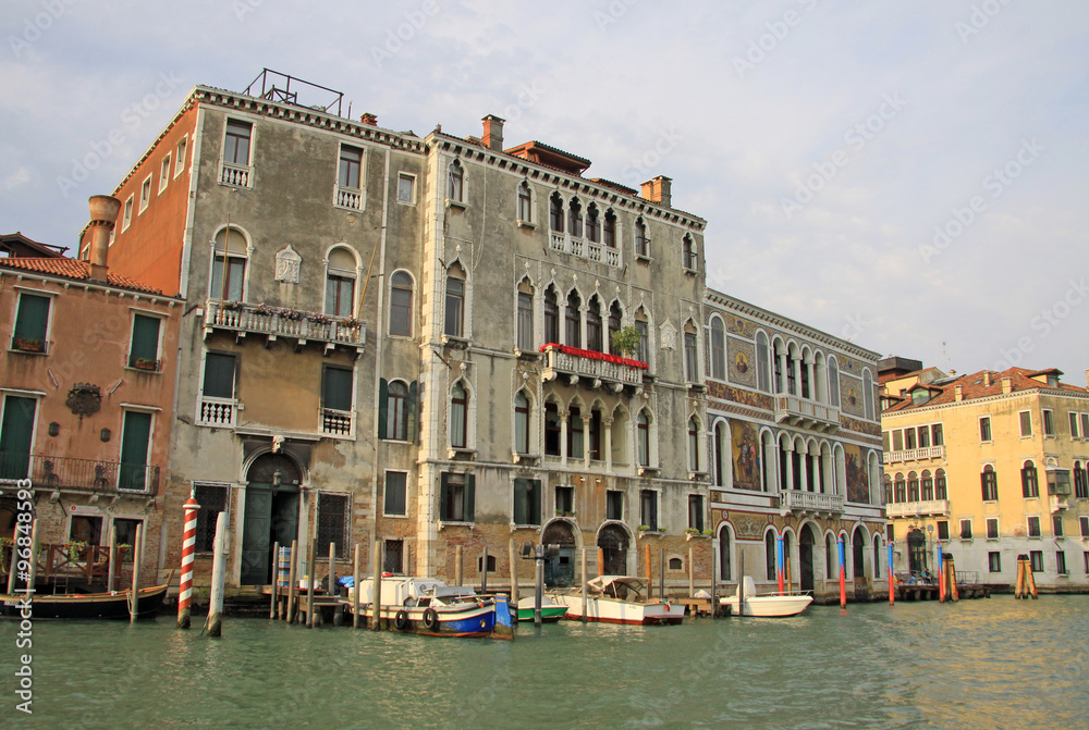 VENICE, ITALY - SEPTEMBER 03, 2012: Old typical buildings on Grand Canal and parked gondolas, Venice, Italy