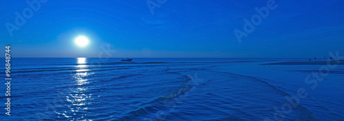 Moonlight over sea in summer photo