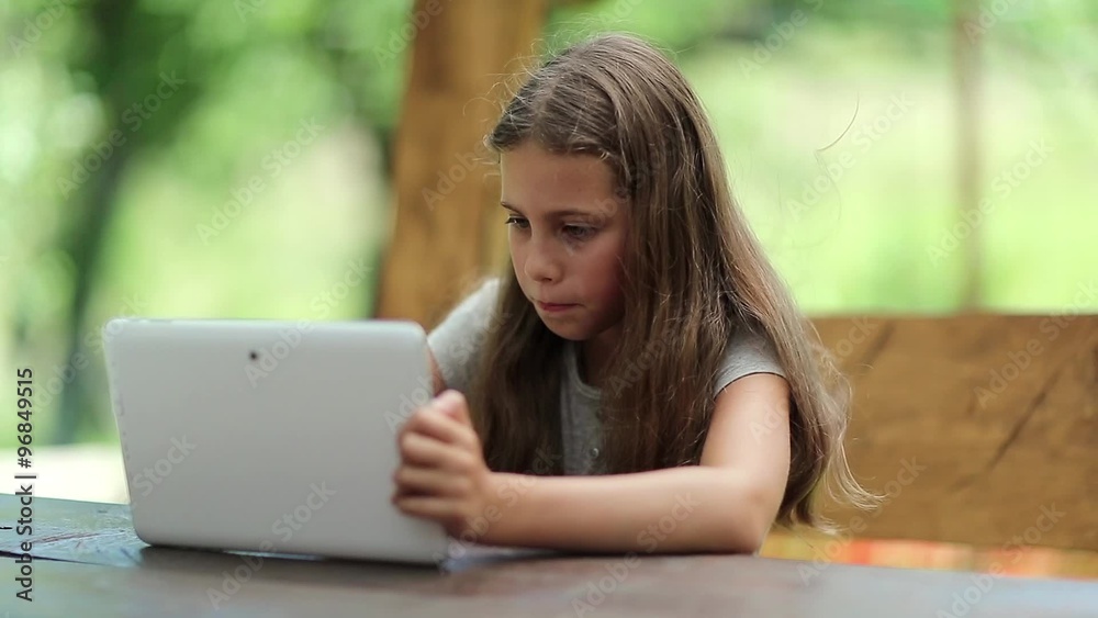 Beautiful girl with tablet computer sits on the bench in summerhouse. Girl playing the game on his tablet computer. Little girl with Tablet-PC sits on the bench in bower
Beautiful girl with tablet computer sits on the bench in summerhouse. Girl playing the game on his tablet computer. Little girl with Tablet-PC sits on the bench in bower