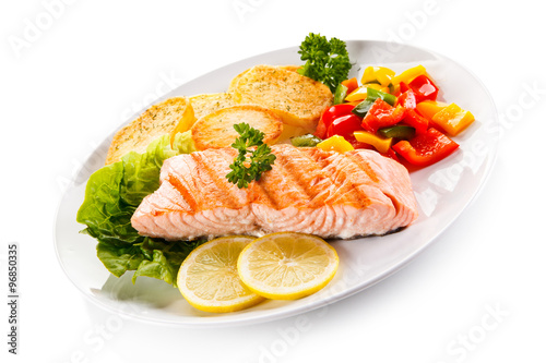 Fried salmon and vegetables on white background 